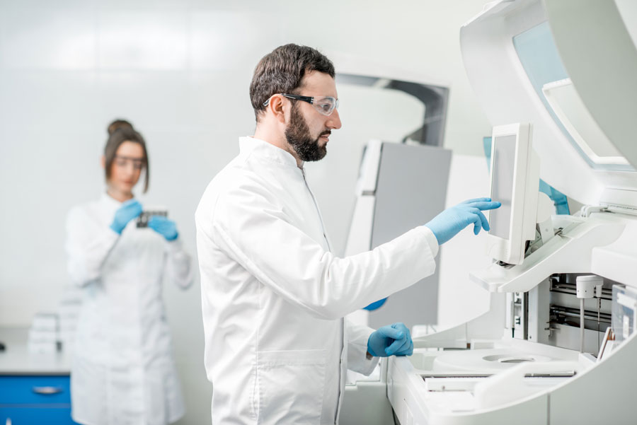 scientist and lab technician study a liquid biopsy for breast cancer - biomark diagnostics